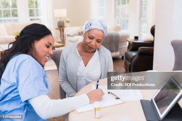 nurse documents the patient's concerns - long term care stock pictures, royalty-free photos & images