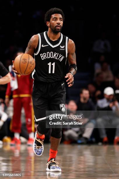 Kyrie Irving of the Brooklyn Nets dribbles during the first half of the Eastern Conference 2022 Play-In Tournament against the Cleveland Cavaliers at...