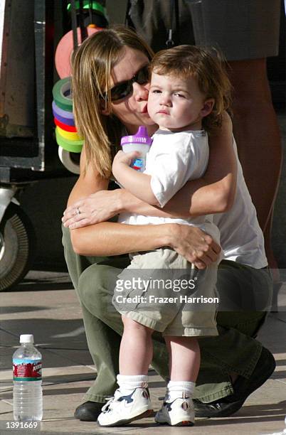 Actress Calista Flockhart kisses her son, Liam, on the set of her boyfreind, actor Harrison Ford's upcoming movie, "Two Cops" on Rodeo Drive on...