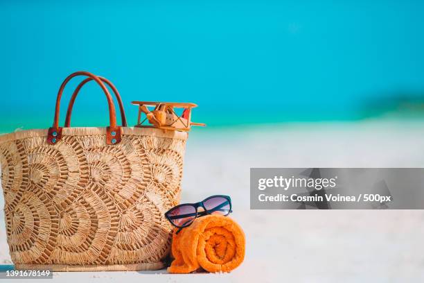 beach accessories - bag,straw hat,sunglasses on white beach - beach bag stock pictures, royalty-free photos & images