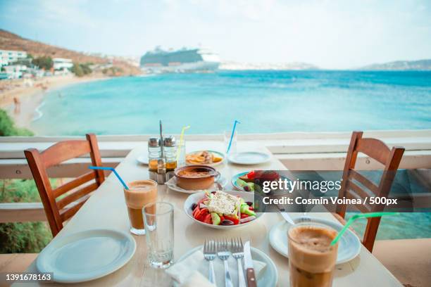 outdoor cafe on a street of typical greek traditional village - aegean food ストックフォトと画像