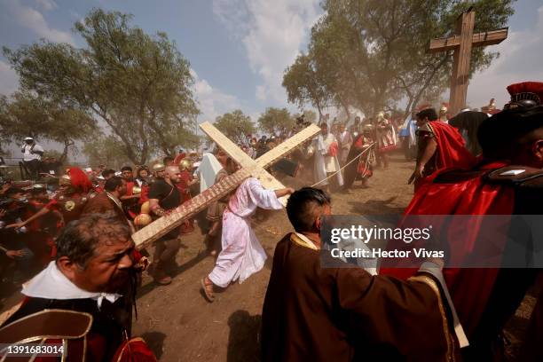 An actor representing Jesus Christ walks towards the cross where he will be crucified during the Passion Play of Iztapalapa on April 15, 2022 in...