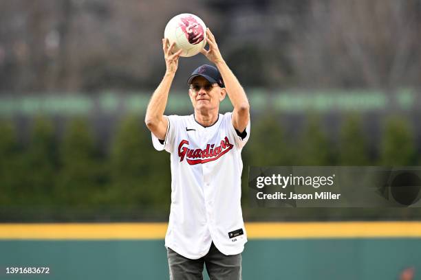 Actor and Cleveland Guardians fan Tom Hanks holds his co-star Wilson before throwing out the ceremonial first pitch prior to the home opener against...