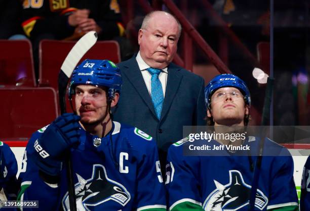 Head coach Bruce Boudreau of the Vancouver Canucks looks on from the bench during their NHL game against the Arizona Coyotes at Rogers Arena April...