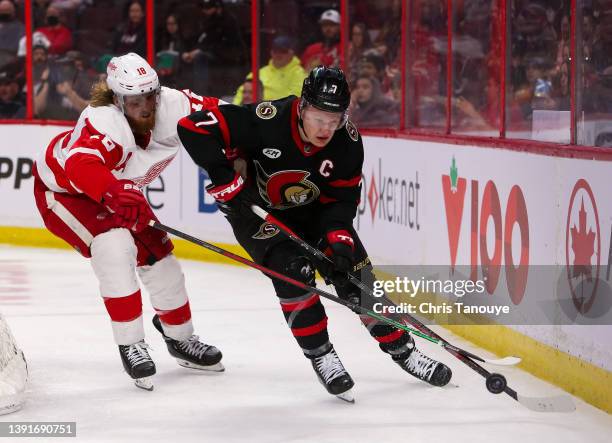 Marc Staal of the Detroit Red Wings battles with Brady Tkachuk of the Ottawa Senators at Canadian Tire Centre on April 03, 2022 in Ottawa, Ontario.