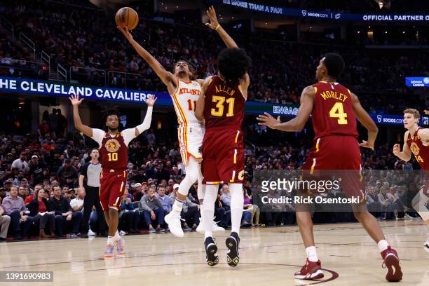 Trae Young of the Atlanta Hawks shoots on Jarrett Allen of the Cleveland Cavaliers in the first half at Rocket Mortgage Fieldhouse on April 15, 2022...
