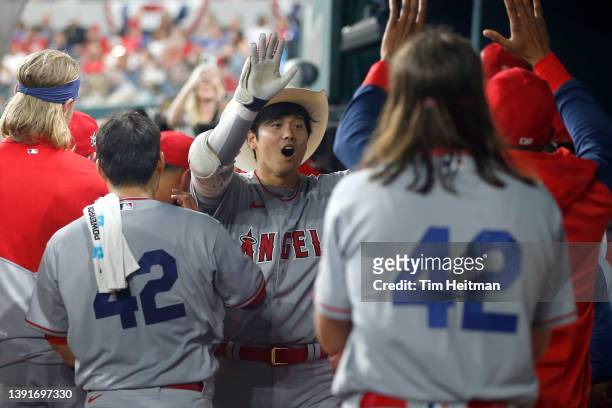 Shohei Ohtani of the Los Angeles Angels is congratulated after hitting a home run in the fifth inning against the Texas Rangers at Globe Life Field...