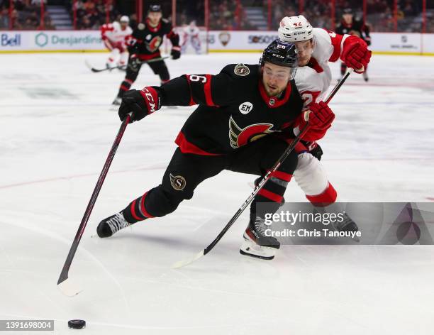 Kyle Criscuolo of the Detroit Red Wings battles with Erik Brannstrom of the Ottawa Senators during the first period at Canadian Tire Centre on April...