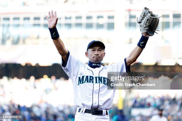 Ichiro Suzuki﻿ raises his arms to the stadium fans before throwing out the ceremonial first pitch prior to the Seattle Mariners' home opener against...