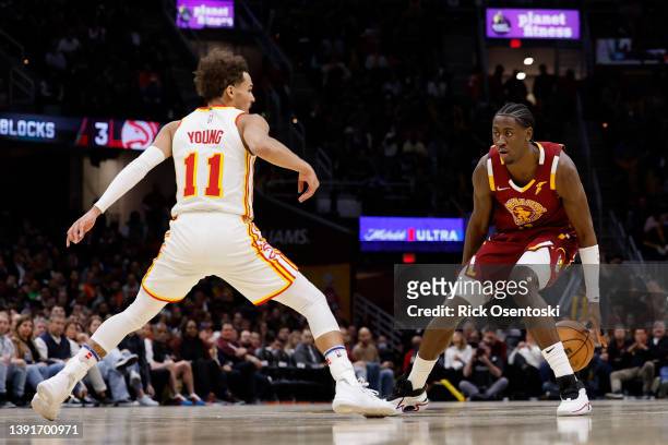Caris LeVert of the Cleveland Cavaliers dribbles on Trae Young of the Atlanta Hawks in the second half at Rocket Mortgage Fieldhouse on April 15,...