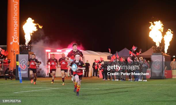 Crusaders captain Scott Barrett with a young fan who got to bring the ball out during the round four Super Rugby Pacific match between the Crusaders...