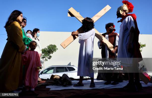 Catholics participate in a traditional Via Crucis procession through the Boyle Heights neighborhood during Holy Week on April 15, 2022 in Los...