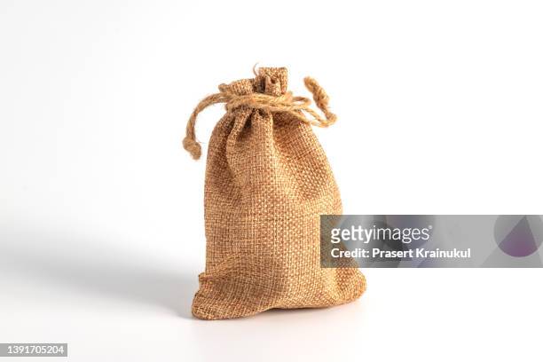 brown small burlap bag with rope on white background - jute ストックフォトと画像