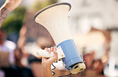Shot of a protester holding a megaphone during a rally