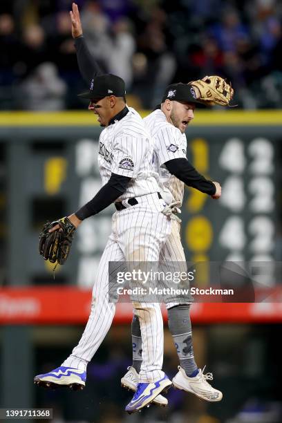 Alan Trejo and Garrett Hampson of the Colorado Rockies celebrate after the last out against the Chicago Cubs at Coors Field on April 15, 2022 in...