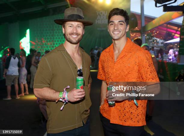 Glen Powell and Taylor Zakhar Perez enjoy a Heineken at the Heineken House at the 2022 Coachella Valley Music and Arts Festival on April 15, 2022 in...