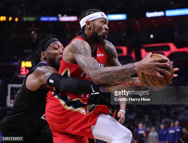 Brandon Ingram of the New Orleans Pelicans drives past Robert Covington of the LA Clippers to score during a 105-101 Pelican win in an NBA play-in...