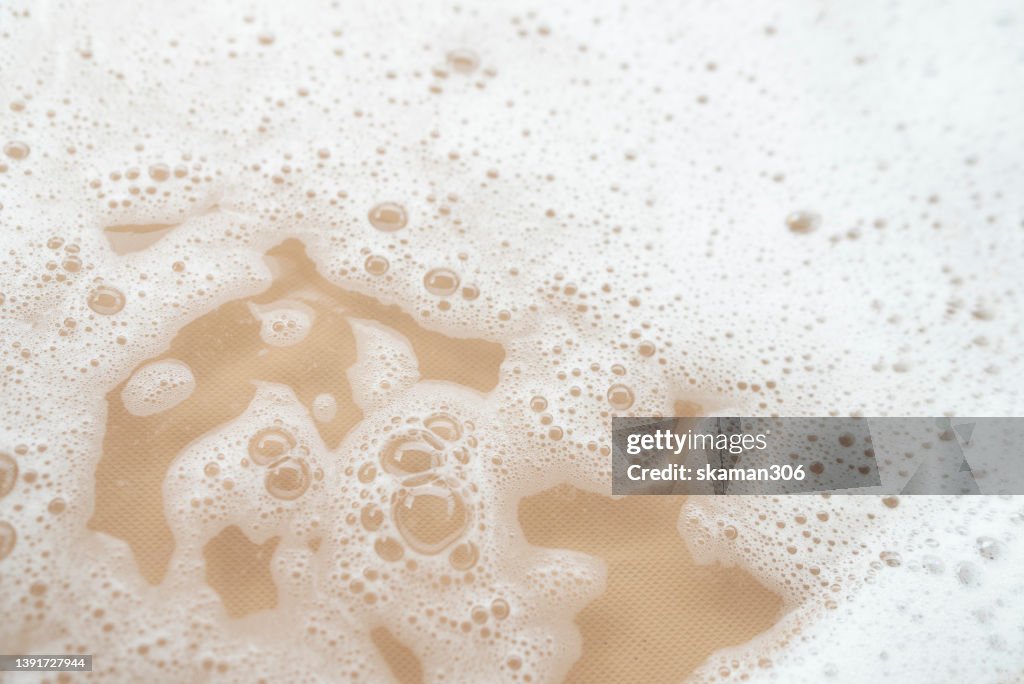 Top view movement of bath foam inside bathtub copy space