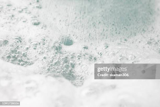 close up texture surface of the bath foam inside bathtub - waschmittel stock-fotos und bilder