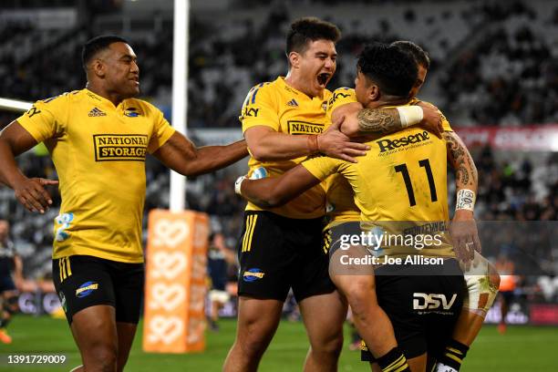 The Hurricanes celebrate a try scored by Salesi Rayasi of the Hurricanes during the round nine Super Rugby Pacific match between the Highlanders and...