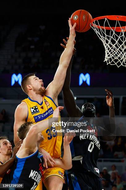 Jack Salt of the Bullets and Jo Lual-Acuil of United contest the ball during the round 20 NBL match between Melbourne United and Brisbane Bullets at...