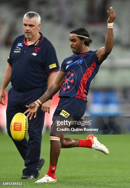 Kysaiah Pickett of the Demons warms up while Mark Williams watches on during the round five AFL match between the Melbourne Demons and the Greater...