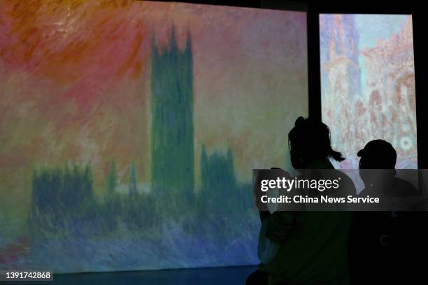 People visit the "Monet & Friends" Immersive Light and Shadow Exhibition at Dewey Center on April 15, 2022 in Beijing, China.