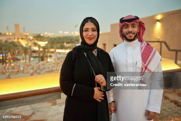 porträt eines saudischen paares, das in der abenddämmerung die ruinen von at-turaif besucht - portrait frau arabisch frontal stock-fotos und bilder