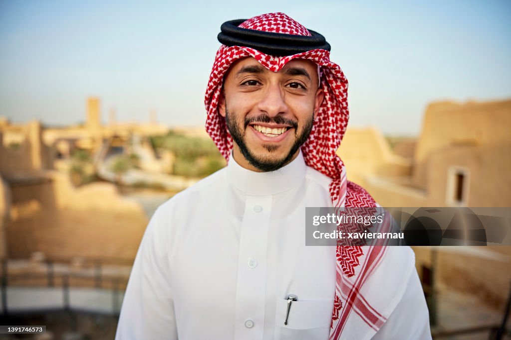 Portrait of cheerful Saudi man visiting At-Turaif ruins