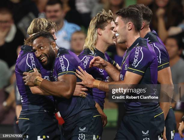 Justin Olam of the Storm celebrates after scoring a try during the round six NRL match between the Melbourne Storm and the Cronulla Sharks at AAMI...