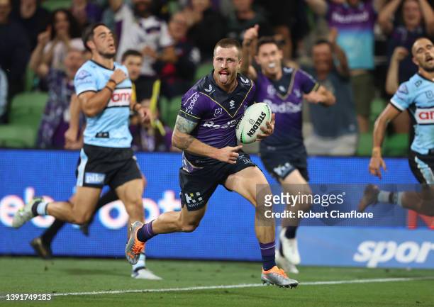 Cameron Munster of the Storm celebrates on his way to scoring a try during the round six NRL match between the Melbourne Storm and the Cronulla...