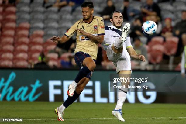 Nicholas D'Agostino of the Victory and Daniel dos Santos Penha of the Jets challenge for the ball during the A-League Mens match between Newcastle...