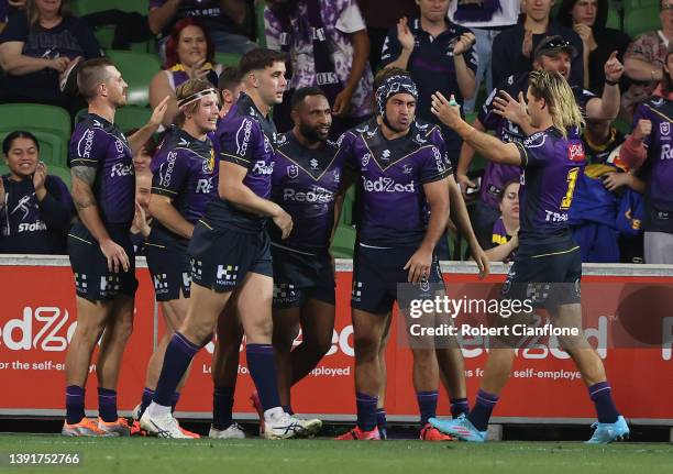 Justin Olam of the Storm celebrates after scoring a try during the round six NRL match between the Melbourne Storm and the Cronulla Sharks at AAMI...