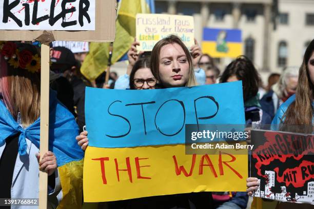Protesters demonstrate in a march against Russian military aggression in the ongoing wars in Ukraine and Syria, on April 16, 2022 in Berlin, Germany....