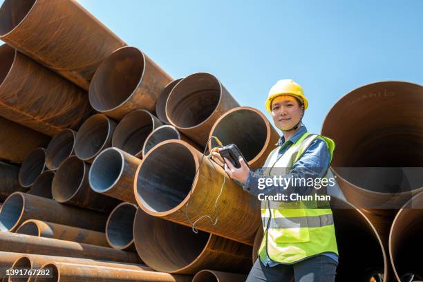 a female engineer used a tester to test steel pipes in an oil plant - mining exploration stock pictures, royalty-free photos & images