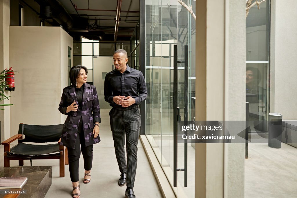 Riyadh business colleagues walking and talking