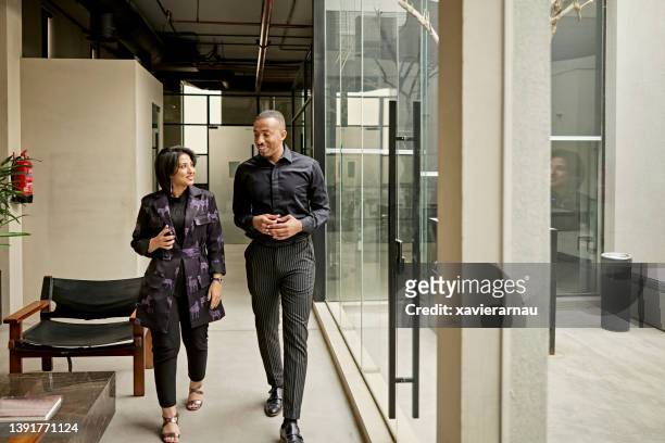 riyadh business colleagues walking and talking - middle east stock pictures, royalty-free photos & images