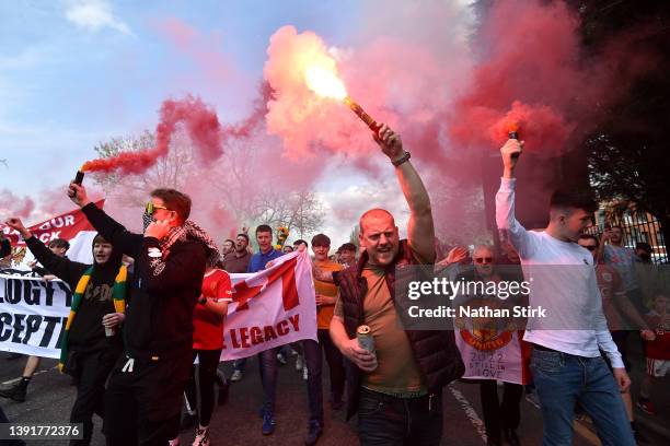 Manchester United fans set off flares while taking part in a protest outside the stadium prior to the Premier League match between Manchester United...