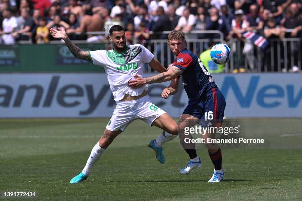Gianluca Scamacca of US Sassuolo battles for possession with Matteo Lovato of Cagliari Calcio during the Serie A match between Cagliari Calcio and US...