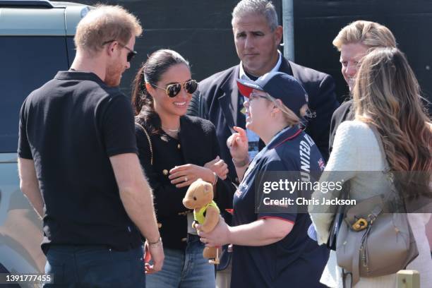 Prince Harry, Duke of Sussex and Meghan, Duchess of Sussex talk to a member of Team Great Britian during the Jaguar Land Rover Driving Challenge on...