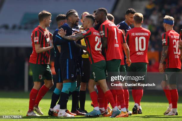 Kevin-Prince Boateng of Hertha BSC reacts with Iago of Augsburg after a foul during the Bundesliga match between FC Augsburg and Hertha BSC at...