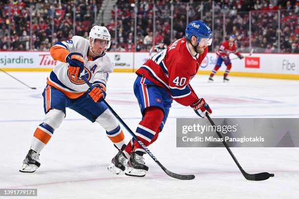Brock Nelson of the New York Islanders challenges Joel Armia of the Montreal Canadiens during the second period at Centre Bell on April 15, 2022 in...