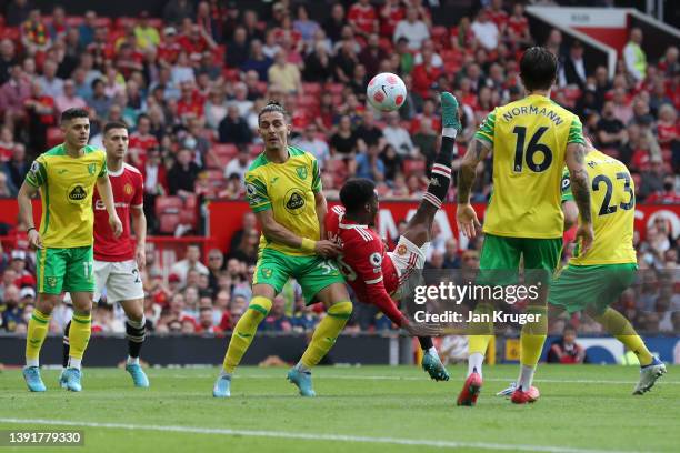 Anthony Elanga of Manchester United shoots and misses whilst under pressure from Dimitris Giannoulis of Norwich City during the Premier League match...