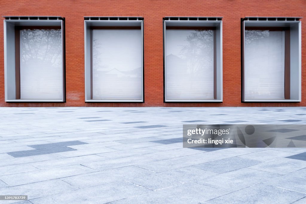 White shop window on red brick wall