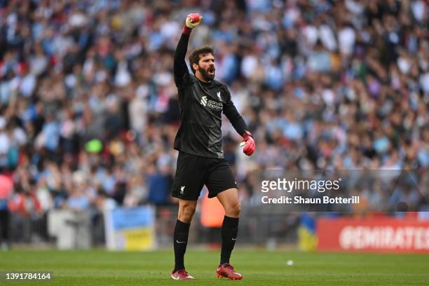 Alisson Becker of Liverpool celebrates after their side's first goal scored by Ibrahima Konate during The Emirates FA Cup Semi-Final match between...