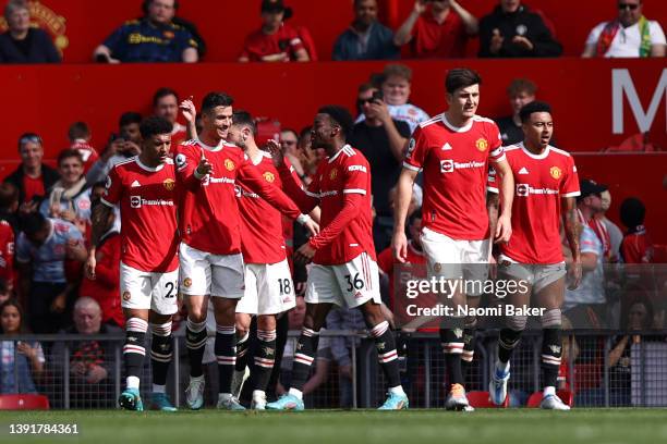 Cristiano Ronaldo of Manchester United celebrates with team mate Anthony Elanga after scoring their sides second goal during the Premier League match...