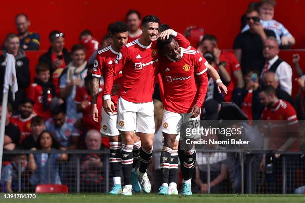 Cristiano Ronaldo of Manchester United celebrates with team mate Anthony Elanga after scoring their sides second goal during the Premier League match...