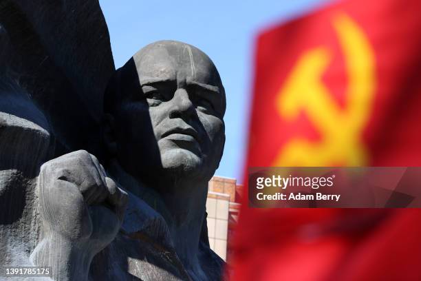Statue of German Communist leader Ernst Thälmann is seen behind a Soviet flag at a commemoration of the 136th anniversary of his birth at the park...
