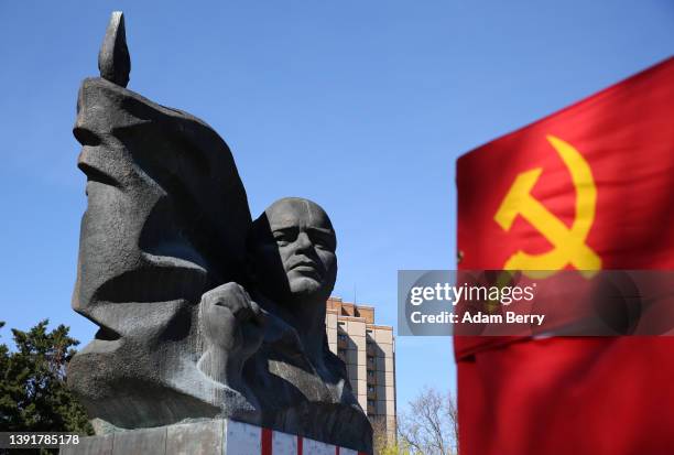 Statue of German Communist leader Ernst Thälmann is seen behind a Soviet flag at a commemoration of the 136th anniversary of his birth at the park...