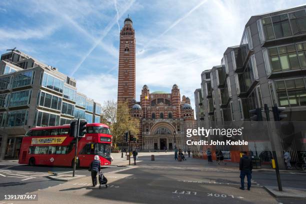 General view of a red London double decker bus passing Westminster Cathedral by architect John Francis Bentley in Victoria Street on April 14, 2022...